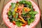 Bright salad with vegetables: spinach, tomatoes, olives, onion,