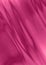 Bright satin background with wavy folds of crimson and pink stripes lying at an angle