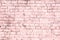 Bright saturated abstract pink background from old brick wall