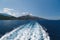 Bright sea water trail behind a cruise ship summer time. Ferry boat leaves a trail in a blue and clear water of