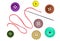 Bright sewing buttons and needle with thread isolated on white