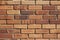 Bright shabby chic brown and tan brick wall texture background with crumbling bricks