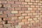 Bright shabby chic brown and tan brick wall texture background with crumbling bricks