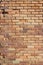 Bright shabby chic brown and tan brick wall texture background with crumbling bricks