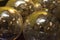 Bright, shiny, silver-colored metallic balls are viewed close-up and in a small grouping.