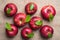 Bright shiny wet red apples with green leaves and water drops on