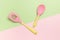 Bright silicone spatula and spoon on a two-tone background