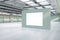 Bright spacious concrete warehouse garage interior with empty white mock up poster. Space and design concept.