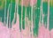 Bright spots and stains of pink and green paint on the canvas. Abstract background.