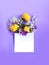 Bright spring flower arrangement.Yellow flowers of trolius europaeus on a lilac background and a white piece of paper for congratu