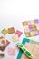 Bright square pieces of fabric, quilting tools, sewing equipment, traditional patchwork, space for text