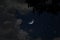 Bright stars and clouds in crescent night