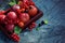 Bright still life with red berries on a blue-green marble background, copy space for your text