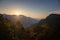 Bright stunning amazing sunrise in the mountains of Sri Lanka, the sun rises from behind the mountains. Beautiful landscape