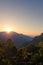 Bright stunning amazing sunrise in the mountains of Sri Lanka, the sun rises from behind the mountains. Beautiful landscape