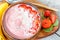 Bright summer strawberry-banana smoothie bowl with coconut.