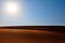 Bright sun, clear blue sky and rippled desert sand. Arabian Desert, Riyadh, Saudi Arabia