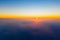 Bright sun rises on horizon above clouds, aerial landscape. Morning concept. Colors in nature