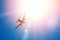 Bright sun in the sky and a flying passenger plane in height. The concept of tourism, vacation, travel