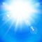 Bright Sunburst with radiating rays in a clear blue sky.