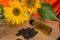 Bright sunflowers with seeds and bottle of oil