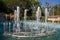 Bright Sunny day in the Children`s Park.Several jets of the fountain shot up