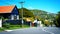 Bright sunny day in a steep quiet street of suburbian Wellington with mountains in the distance.