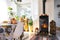 Bright sunny interior of the house with Black Metal Steel fireplace stove with fire and firewood with halloween decor and autumn