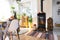 Bright sunny interior of the house with Black Metal Steel fireplace stove with fire and firewood with halloween decor and autumn