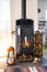 Bright sunny interior of the house with Black Metal Steel fireplace stove with fire and firewood with halloween decor and autumn