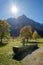 Bright sunny karwendel landscape in autumn with wooden standpipe