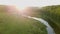 Bright sunny rays falling on green forest by river. Stock footage. Warm sunlight falls on beautiful dense forest with
