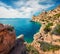 Bright sunny view of Melagavi lighthouse in the Corinth Gulf. Picturesque spring seascape in the Greece, Europe. Beauty of nature