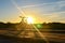 Bright sunrise on the road near the river on the background of a bicycle. Mountain bike in forest with sun rays.