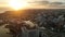 Bright sunset over tall waterfront apartment buildings and sprawling city