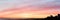 Bright sunset sky and silhouette of a construction site on it panoramic view