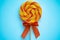 Bright swirl lollipop on blue background