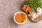 Bright tasty pureed carrot soup in clay bowl