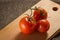 Bright tomatoes with a green branch and drops of water