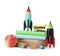 Bright toy rockets and school supplies on background