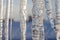 Bright transparent icicles against the background of the blue sky.