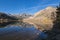 Bright transparent water mirroring mountains and forest