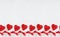 Bright valentine`s day background - sweet red lollipops hearts on white wood board as seamless border, layout for banner, header.