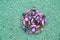 Bright vintage beads from pink and purple beads on a green background