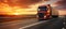 Bright white pickup truck driving on a deserted road with stunning sunset colors in the background