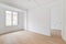 Bright white spacious unfurnished apartment with an window and wooden textured laminate. Concept of modern building or