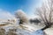 Bright winter scenery, with frozen river and trees