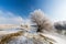 Bright winter scenery, with frozen river and trees