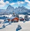 Bright winter view of Alpe di Siusi village with Plattkofel peak on background.