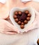 Bright woman holding a bowl with chocolates